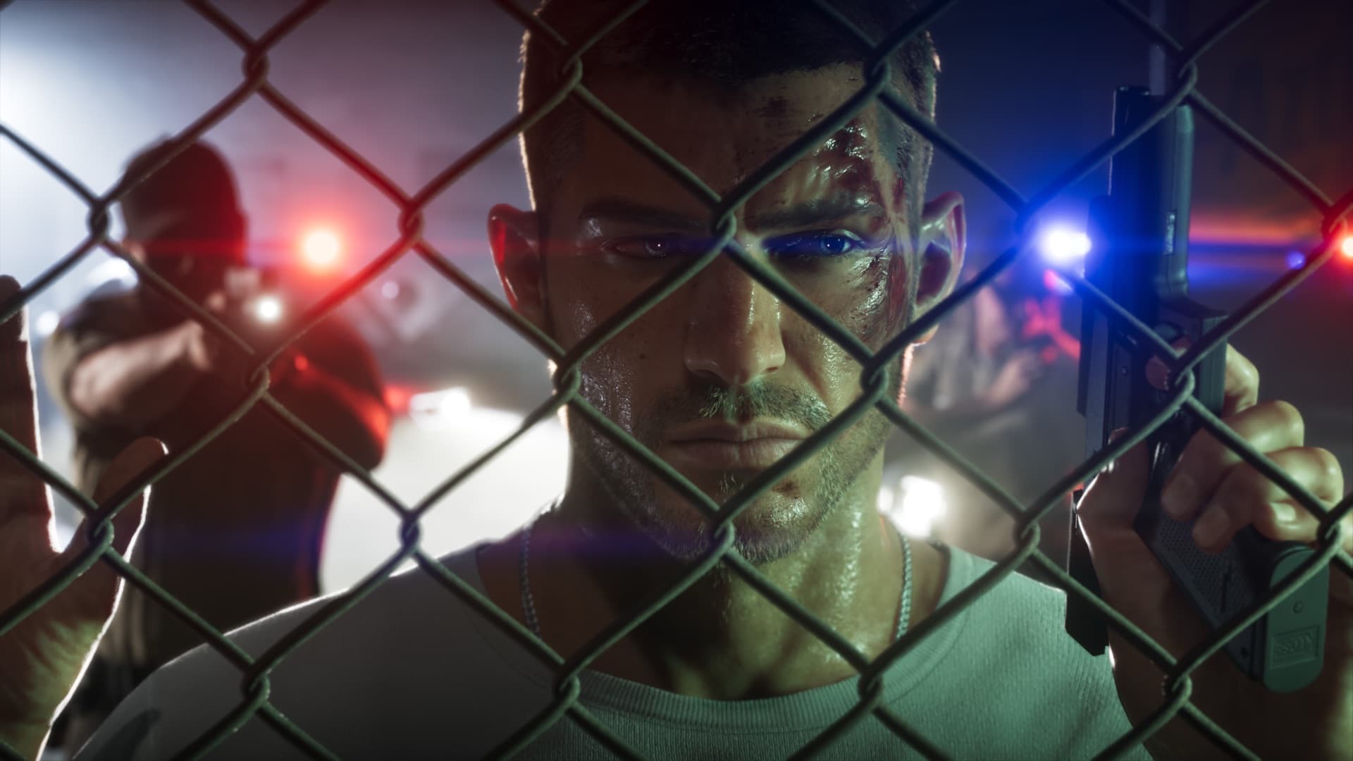 Jason Duval behind a chain-link fence as police lights flash behind him